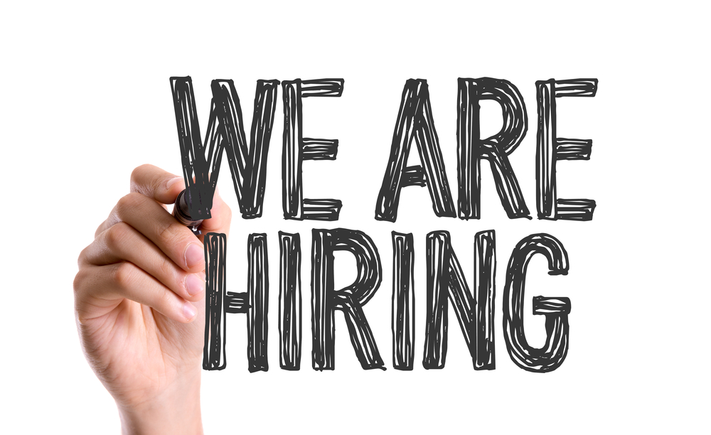 Hand with marker writing We Are Hiring Hand with marker writing We Are Hiring
